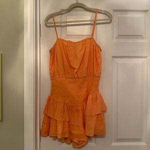 Peach ruffled romper. Size large, never worn.
